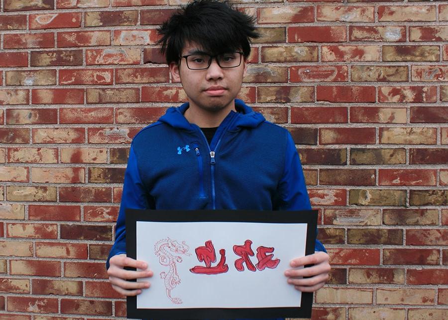 A student holding a welcome sign